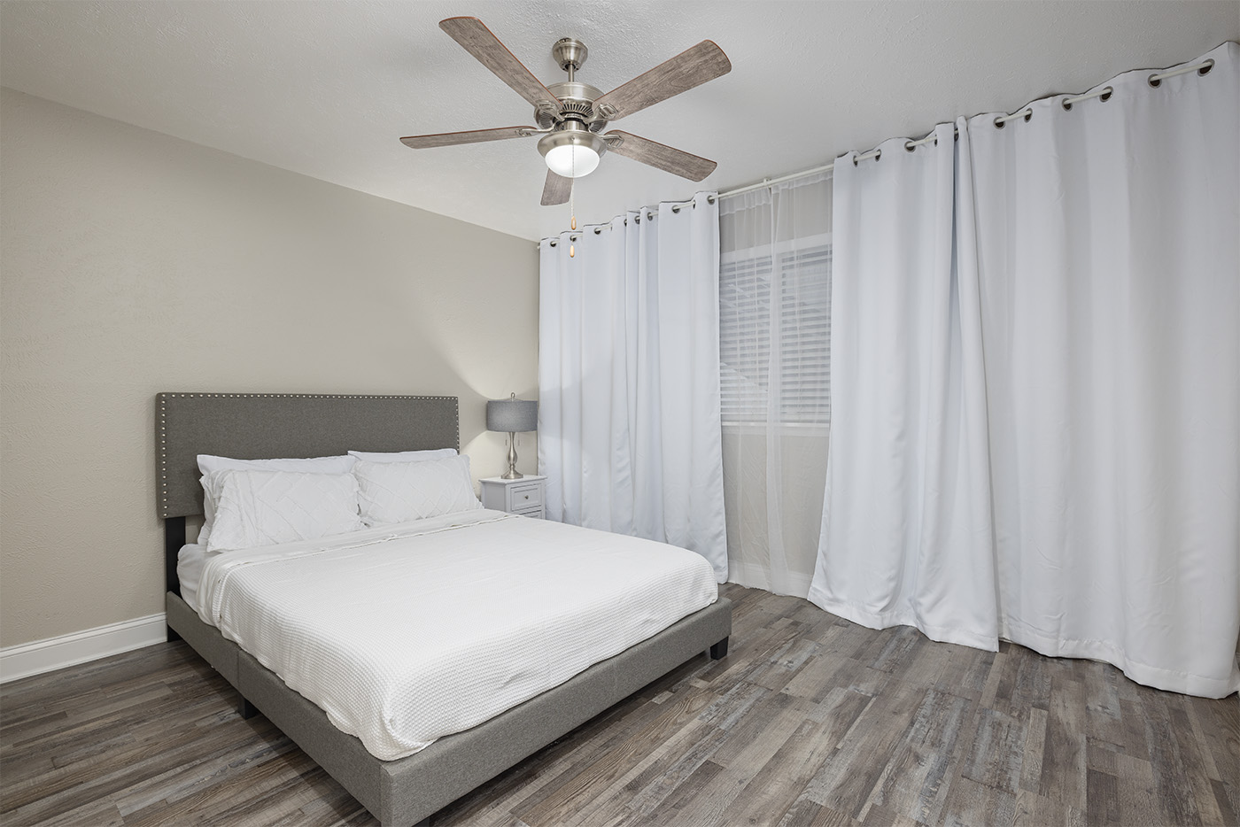 Cedar Springs bedroom A with layered bedding and botanical element