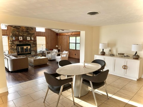 Dining area with dramatic overhead arrangement and warm candlelight tones
