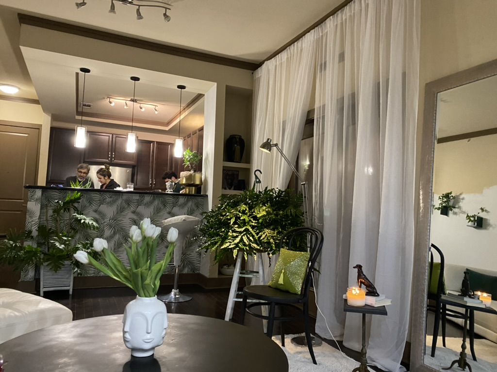 Statement moment: arc lamp, botanical print pillow, and carefully placed accent